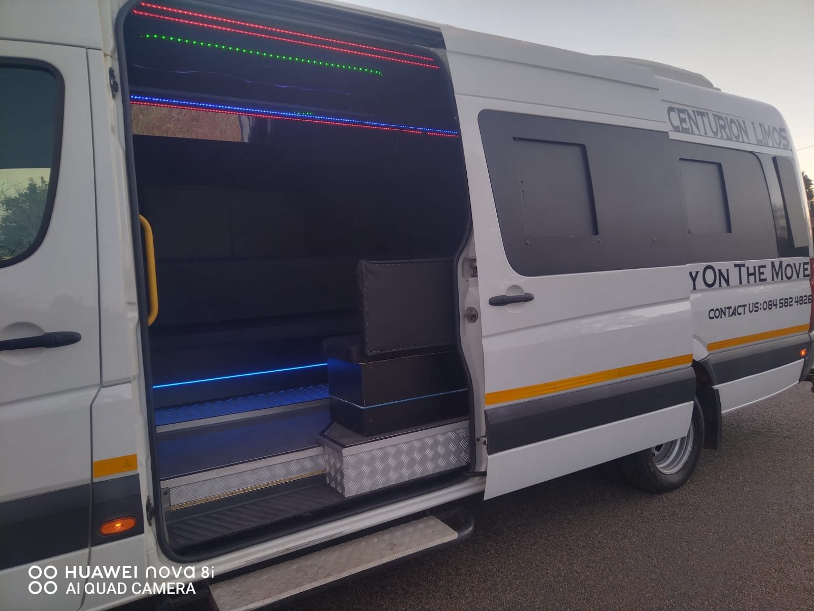 Centurion Limos party van with the sliding door open and LED lights on